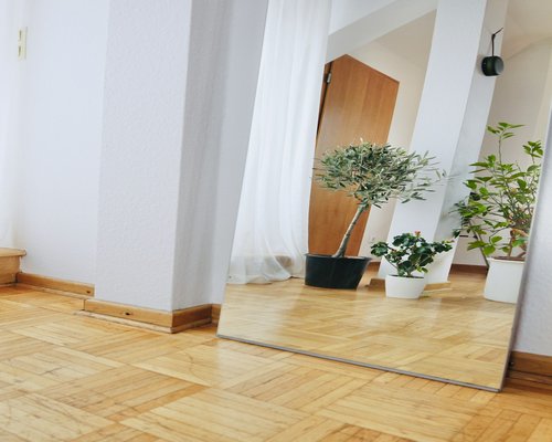 Woman performing gentle yoga stretches at home in a bright room